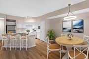 Alpharetta apartment for rent - A modern kitchen with a dining table set for four.