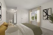 Quincy apartment for rent - A bedroom with a large bed and a window with curtains.