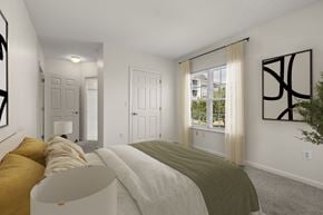 Quincy apartment for rent - A bedroom with a large bed and a window with curtains.