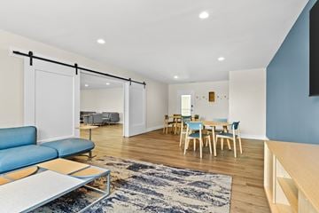 Quincy apartment for rent - A living room with a blue couch and a rug.