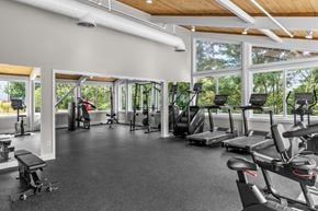 Quincy apartment for rent - A gym with a variety of equipment including treadmills, weights, and exercise machines.