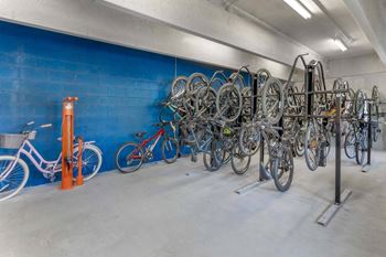 A bike rack full of bicycles in a parking garage