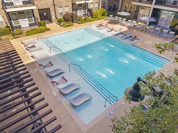 A pool with a few chairs