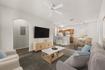 Orange City apartment for rent - A living room with a grey couch and a wooden coffee table.