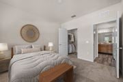 Orange City apartment for rent - A bedroom with a large bed and a wooden bench.