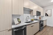 Suwanee apartment for rent - A modern kitchen with wooden cabinets and stainless steel appliances.