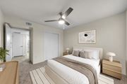 Austin apartment for rent - A bedroom with a large bed and a ceiling fan.