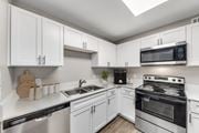 Austin apartment for rent - A kitchen with white cabinets and stainless steel appliances.