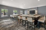 Austin apartment for rent - A theater room with a large TV, large table and chairs.