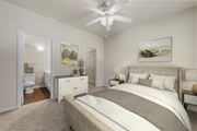 Austin apartment for rent - A bedroom with a large bed and a ceiling fan.