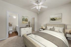 Austin apartment for rent - A bedroom with a large bed and a ceiling fan.