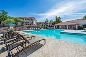 Tucson apartment for rent - Resort-Style swimming pool surrounded by lounge chairs and umbrellas
