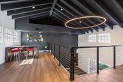 Tucson apartment for rent - A modern dining area with a black railing and a wooden floor.