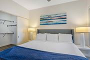 Chamblee apartment for rent - A bedroom with a large bed and a painting on the wall.