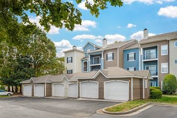 Charlotte apartment for rent - A row of houses with attached garages in front of a tree.