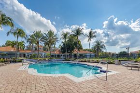 Boynton Beach apartment for rent - A pool surrounded by palm trees