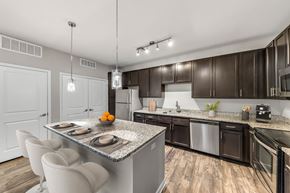Land O Lakes apartment for rent - A modern kitchen with a dining table and chairs.