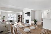 Westborough apartment for rent - A modern dining room with a fireplace and a TV mounted on the wall.