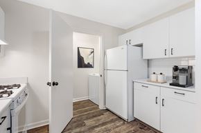 Westborough apartment for rent - A kitchen with white appliances and cabinets at Residences at Westborough Station, Westborough, MA