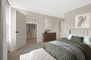 Westborough apartment for rent - A bedroom with a large bed and a wooden dresser.