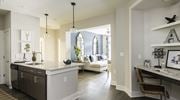 Charleston apartment for rent - A kitchen with a white counter and a brown chair at Wharf 7 Apartments, South Carolina