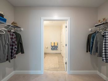 A walk in closet with ample storage space 