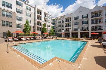 Swimming pool with lounge chairs and umbrella