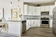 Charlotte apartment for rent - A modern kitchen with white cabinets and stainless steel appliances.