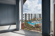 Charlotte apartment for rent - A balcony with a pool and buildings in the background.