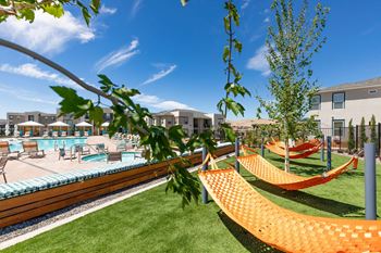 Hammock garden with orange hammocks next to pool