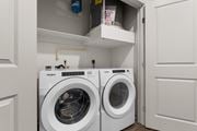 Colorado Springs apartment for rent - A Whirlpool washing machine is sitting in a small laundry room.