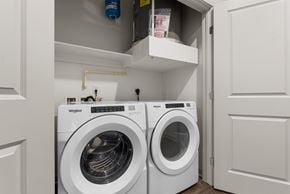 Colorado Springs apartment for rent - A Whirlpool washing machine is sitting in a small laundry room.