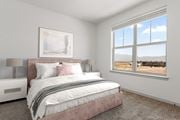 Colorado Springs apartment for rent - A bedroom with a large bed and a painting on the wall.