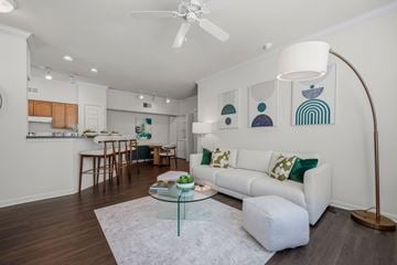 Fort Myers apartment for rent - A living room with a white couch and a glass coffee table.