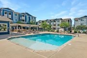 Colorado Springs apartment for rent - A swimming pool in front of apartment buildings.