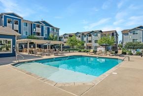 Colorado Springs apartment for rent - A swimming pool in front of apartment buildings.