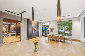Waltham apartment for rent - a dining room with a table and chairs and a large window at The Merc, Waltham, MA