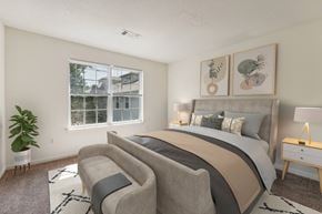 Westborough apartment for rent - a bedroom with a bed and a chair and a window at Residences at Westborough Station, Massachusetts