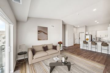 Rochester apartment for rent - A modern living room with a beige couch and a coffee table.