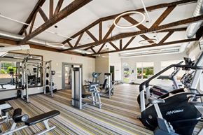 Rochester apartment for rent - A gym with a variety of equipment including treadmills, weights, and exercise machines.at SoRoc On Maine, Rochester, MN 55904