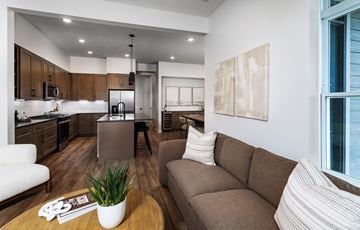 Elkhorn apartment for rent - A modern living room with a brown sofa and a coffee table.