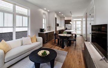 Elkhorn apartment for rent - A modern living room with a white sofa and a black coffee table.