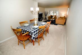 Latham apartment for rent - a dining room table with wooden chairs and a checkered table cloth