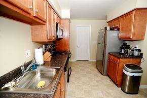 Latham apartment for rent - a kitchen with wooden cabinets and a stainless steel refrigerator