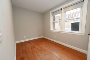 Philadelphia apartment for rent - a bedroom with a wood floor and a large window