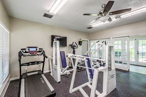 Greenville apartment for rent - A home gym with a treadmill, a stationary bike, and a weight bench.