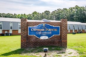 Greenville apartment for rent - A sign for Cypress Pointe Apartments is displayed in front of a grassy area.