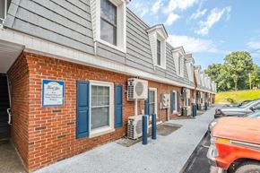 Morganton apartment for rent - A row of houses with a sign that says "Amenities Off" on the front.