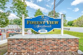 Morganton apartment for rent - A sign for Forest View Apartments is shown in front of a brick wall.
