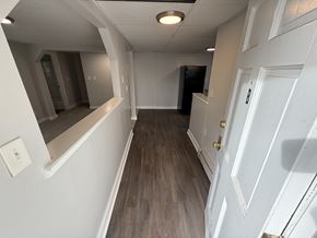 Concord apartment for rent - A hallway with a white door and a mirror on the wall.